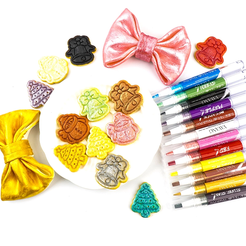 The image shows colorful cookies shaped like bells and Christmas trees, alongside vibrant markers and decorative bows, arranged on a white plate